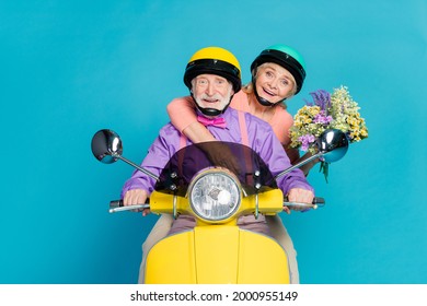 Photo of retired pensioner grey haired husband wife couple hold flowers ride bike isolated on blue color background - Powered by Shutterstock