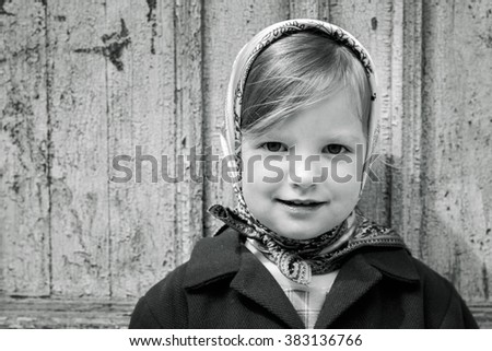 Photo in retro style. Cute little girl in a kerchief. Selective focus.
