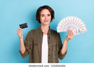 Photo Of Rich Millennial Short Hairstyle Lady Hold Money Card Wear Khaki Shirt Isolated On Blue Color Background