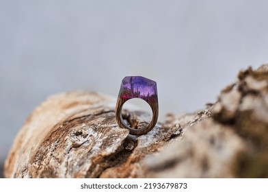 Photo Of A Ring Made Of Epoxy Resin Lying On A Texture Cut Of A Tree. Eco-friendly Material To Create Beautiful Things. Bright Unusual Gift For A Girl. Epoxy Resin Is Often Used For Decor.