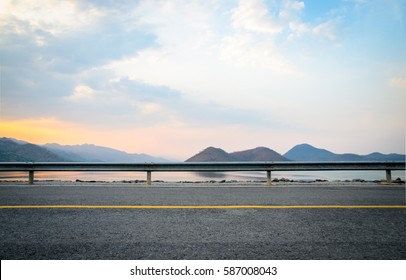 A photo of the road near the dam with sunset scene