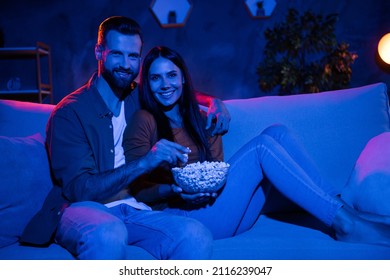 Photo of romantic bonding couple sit cozy couch eat pop corn watch romantic series honeymoon in dark evening room