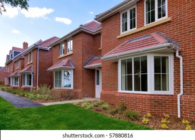 Photo of a row of brand new empty houses for sale on a housing development. - Shutterstock ID 57880816