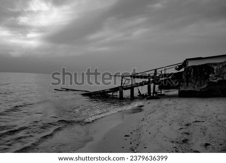 A photo of a rusty, dilapidated shipwreck on the shore of Kish Island in the Persian Gulf.