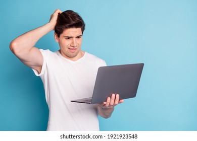 Photo Of Sad Nervous Guy Hold Laptop Wear White T-shirt Hand Head Isolated On Cyan Color Background