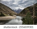 photo of the Salmon River Canyon above Riggins ID with cloudy sky and gravel road