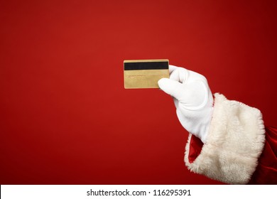 Photo Of Santa Claus Gloved Hand Holding Credit Card