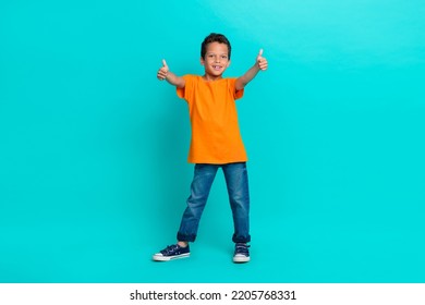 Photo Of Satisfied Boy Learner Raise Two Arm Show Approval Yes Symbol Enjoy Nice Lesson Empty Space Isolated On Cyan Color Background