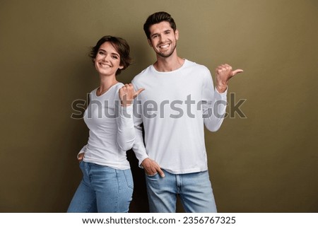 Photo of satisfied cheerful people wear stylish white clothes arm direct special cool offer empty space isolated on brown color background