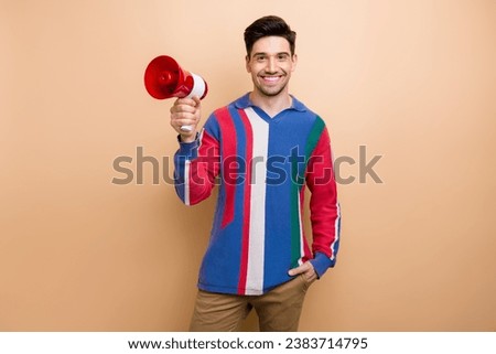 Photo of satisfied friendly person toothy smile hand hold loudspeaker toa isolated on beige color background