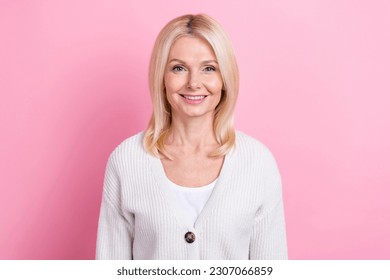 Photo of satisfied funny optimistic senior woman with bob hairstyle dressed knit cardigan smiling isolated on pink color background