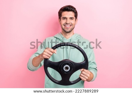 Photo of satisfied glad person arms hold wheel toothy smile isolated on pink color background