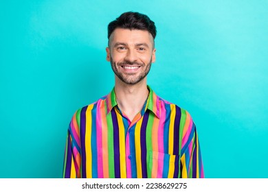 Photo of satisfied glad pleasant man with brunet hair dressed striped shirt dental clinic advert isolated on turquoise color background