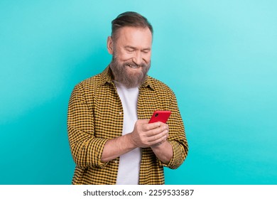 Photo of satisfied man middle age wear stylish yellow shirt enjoy his smartphone remote app online shopping isolated on cyan color background - Shutterstock ID 2259533587