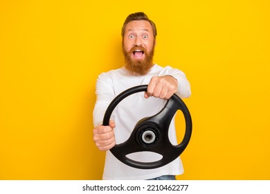 Photo Of Satisfied Man New Owner Driver Enjoy Good Road Repaired Car Open Mouth Reaction Isolated On Yellow Color Background