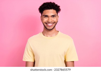 Photo of satisfied optimistic funky guy with afro hairstyle dressed yellow t-shirt toothy smiling isolated on pink color background - Shutterstock ID 2327865579