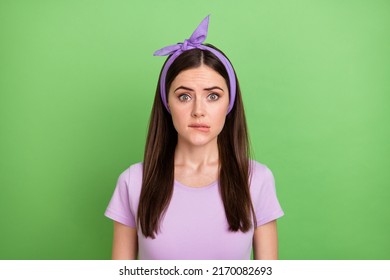 Photo Of Scared Nervous Lady Dressed Purple T-shirt Hairband Biting Lip Isolated Green Color Background