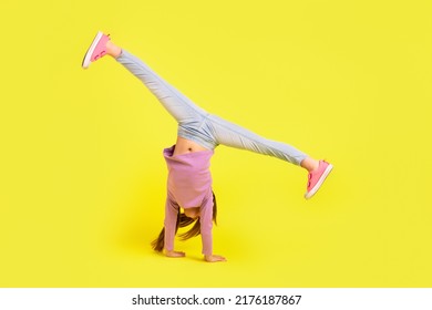 Photo of school child stand on hands doing acrobat practice isolated bright vibrant color background