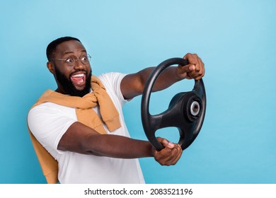 Photo of screaming smiling man riding car fast speed traveling have fun carefree isolated on blue color background