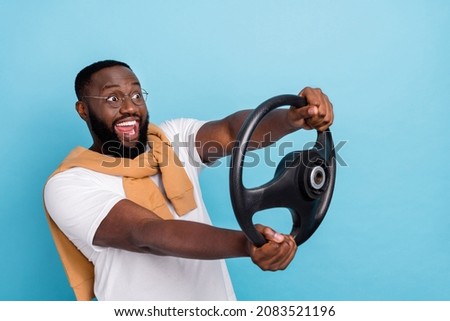 Photo of screaming smiling man riding car fast speed traveling have fun carefree isolated on blue color background
