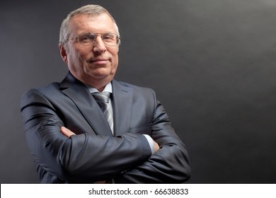 Photo Of Senior Employer Looking At Camera On Black Background