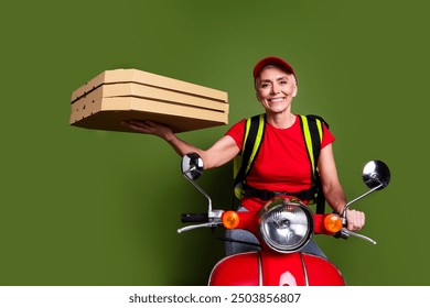 Photo of senior female professional delivery employee thermo bag scooter pizza wear red uniform workwear isolated on khaki color background - Powered by Shutterstock