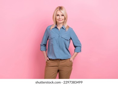 Photo of senior good mood business lady stand hold hands pockets wear smart casual office clothes isolated pink color background - Shutterstock ID 2297383499