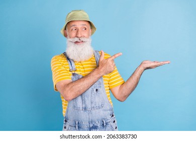 Photo Of Senior Man Happy Positive Smile Indicate Finger Advert Advise Choice Object Isolated Over Blue Color Background