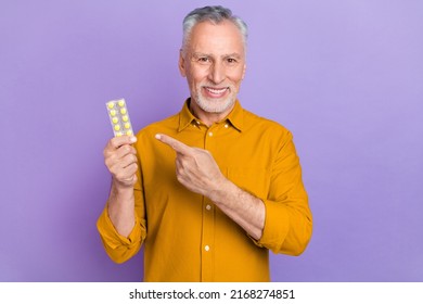Photo of senior man indicate finger meds painkillers promo recommend select isolated over violet color background - Shutterstock ID 2168274851