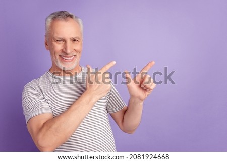 Photo of senior man indicate fingers empty space promotion advert isolated over violet color background