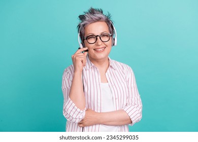 Photo of senior woman administrator call wired headset customer support touch microphone ready for work isolated on blue color background - Powered by Shutterstock