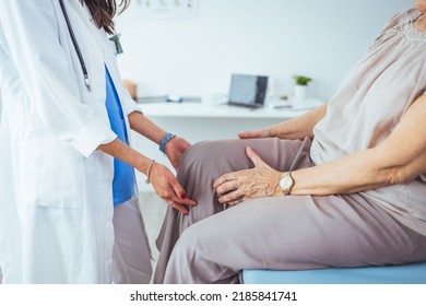 Photo of senior woman having some knee pain. She's at doctor's office having medical examination by a male doctor. The doctor is touching the sensitive area and trying to determine the cause of pain. - Powered by Shutterstock