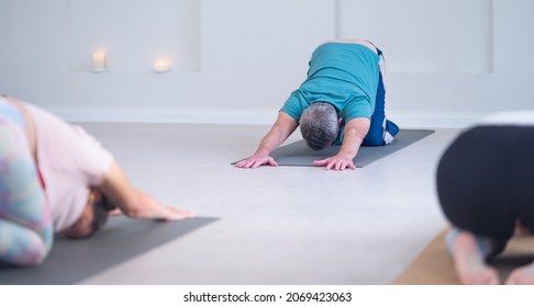 Photo Of A Senior Yoga Instructor, Showing The Pose To Be Done.