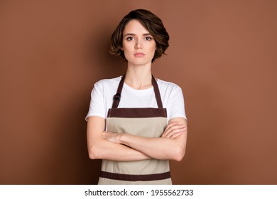 Photo Of Serious Charming Person Folded Arms Look Attentively Camera Isolated On Brown Color Background