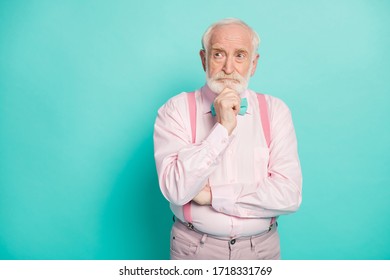 Photo Of Serious Stylish Grandpa Hold Arm On Chin Look Side Empty Space Deeply Minded Wear Pink Shirt Suspenders Bow Tie Pants Isolated Bright Teal Color Background