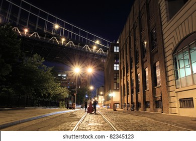 Photo Session On A Street Under The  Manhattan Bridge In Brooklyn NYC At Night