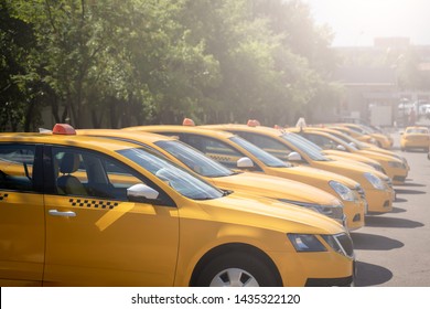 Photo of several yellow taxi on street in summer afternoon