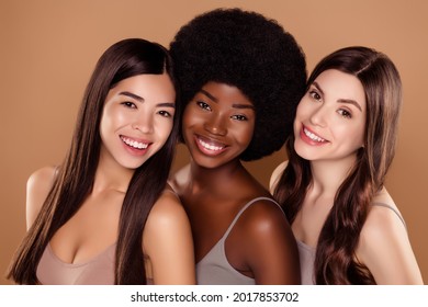 Photo of shiny charming three girlfriends wear crop tops smiling hugging isolated beige color background - Shutterstock ID 2017853702