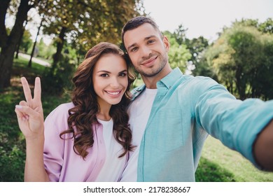 Photo Of Shiny Cute Boyfriend Girlfriend Wear Casual Outfits Walking Tacking Selfie Showing V-sign Enjoying Sunny Weather Outdoors Garden