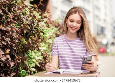 Photo of shiny cute girl dressed pink t-shirt sitting cafe texting modern gadget outdoors uban city town - Powered by Shutterstock