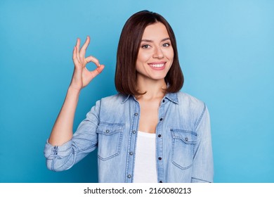 Photo of shiny cute woman wear jeans shirt showing okey sign smiling isolated blue color background - Shutterstock ID 2160080213