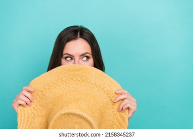 Photo of shiny dreamy lady dressed orange clothes straw hat cover face looking empty space isolated teal color background