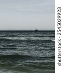 A photo of a ship sailing in the distance on the Baltic Sea