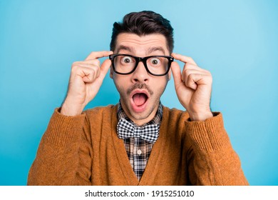 Photo Of Shocked Astonished Young Guy Hold Fingers Glasses Unbelievable Sale Discount Isolated On Blue Color Background