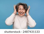 Photo of shocked funky lady old woman grandmother arms hands head looking at camera great news big discount empty space isolated over blue color background. Advertisement concept