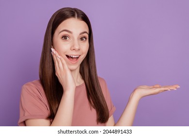 Photo Of Shocked Lady Holding Product Open Hand Offer Isolated On Purple Background