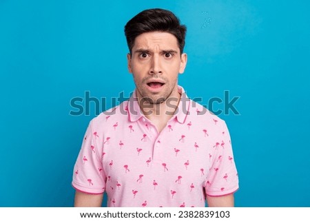 Photo of shocked speechless unsatisfied person open mouth staring cant believe isolated on blue color background