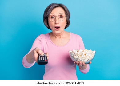 Photo Of Shocked Surprised Amazed Mature Woman Watch Tv Eat Popcorn Head Bad News Isolated On Blue Color Background