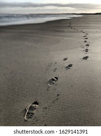 A Photo Of Shoe Prints In Sand At Sunset 2020