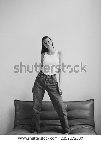 Photo shoot girl model style fashion portrait smile young woman lady white black lifestyle studio shooting beautiful Caucasian happy cute beauty casual staying jeans posing hands face eyes tenderness